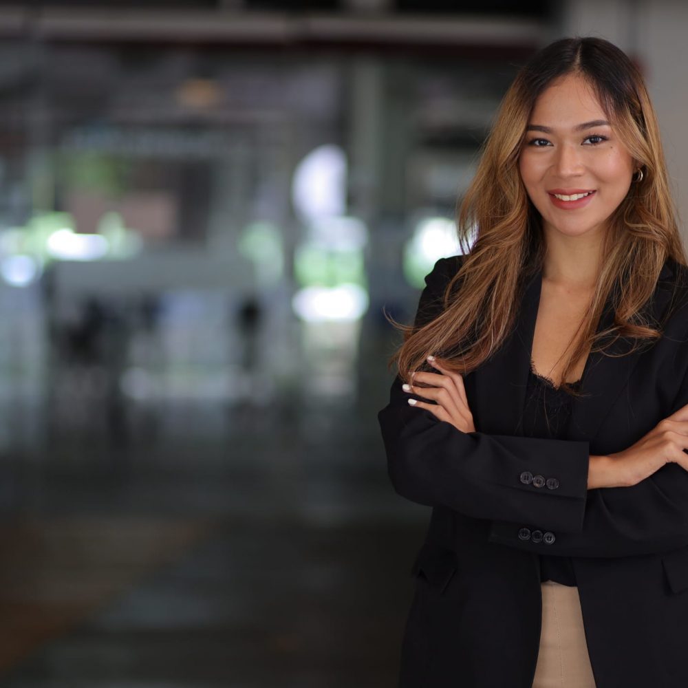 Portrait of a happy charming business woman looking at the camera in the office.